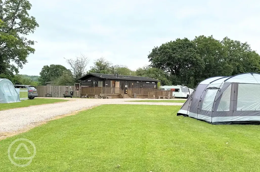 Grass pitches nearby the facilities block at Oakmoor Touring Park
