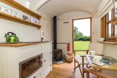 Shepherd's hut interior with a kitchenette and fire place