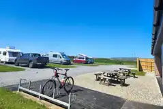 Electric hardstanding pitches and nearby bike rack Electric hardstanding pitches and nearby bike rack
