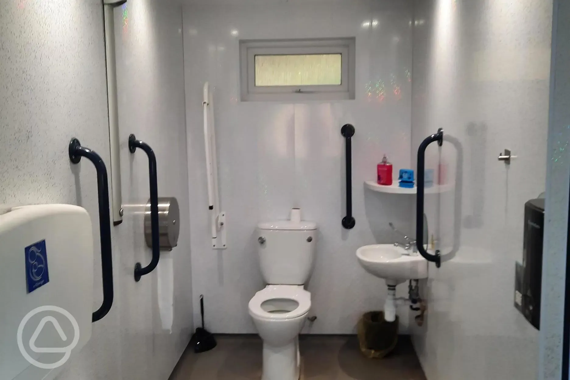 Accessible bathroom with grab rails and baby changing facilities