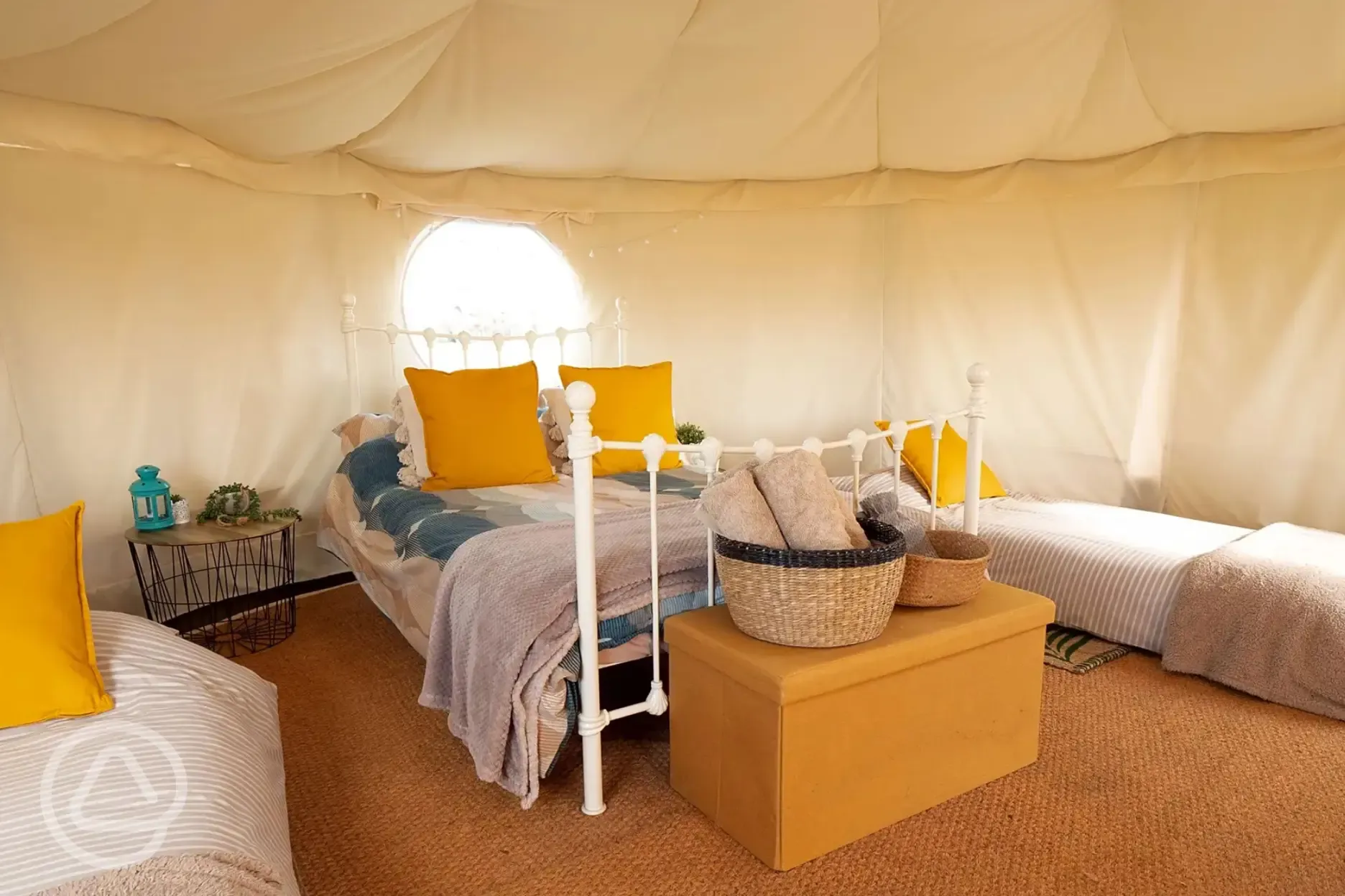 Wanson Nomadic yurt interior with a double bed and singles