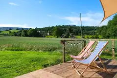 Glamping cabin outdoor deck with tradtional deck chairs Glamping cabin outdoor deck with tradtional deck chairs