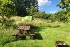 Picnic bench by the grass pitches