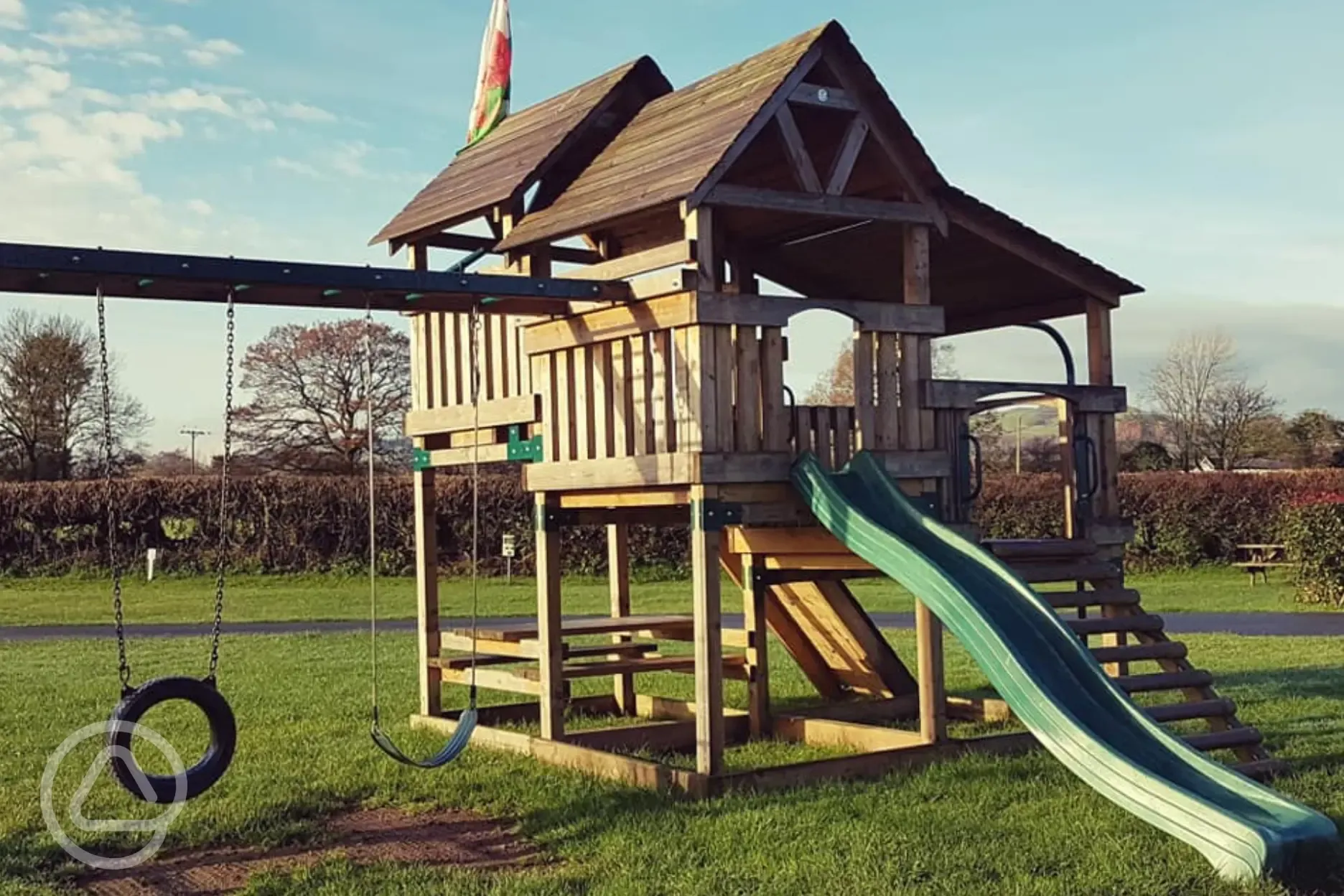 Children's play area with climbing frame, swings and slides