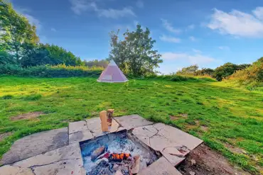Non electric grass pitches with a fire pit at The Batch Campsite