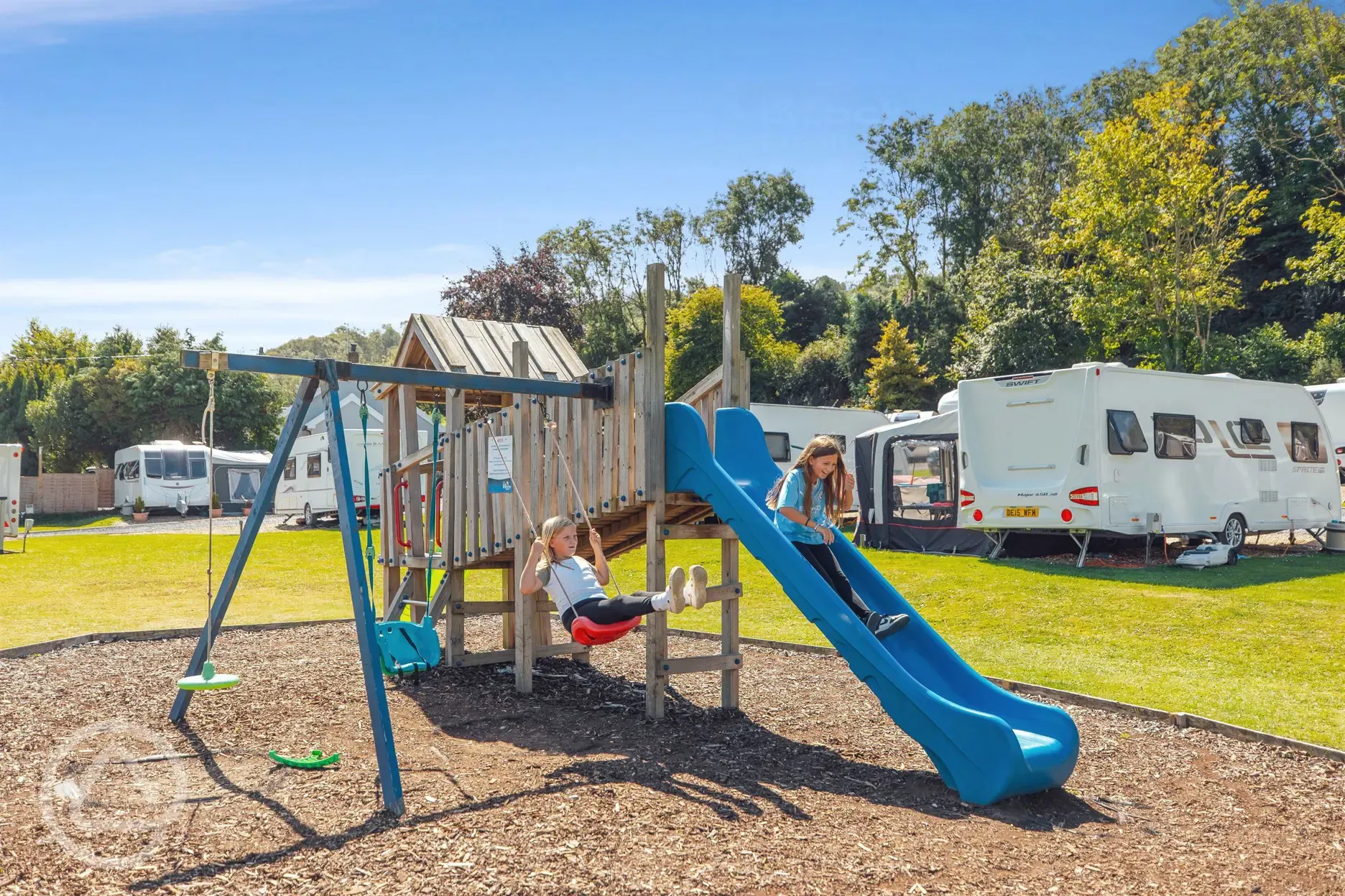 Playground offering swings and slide 