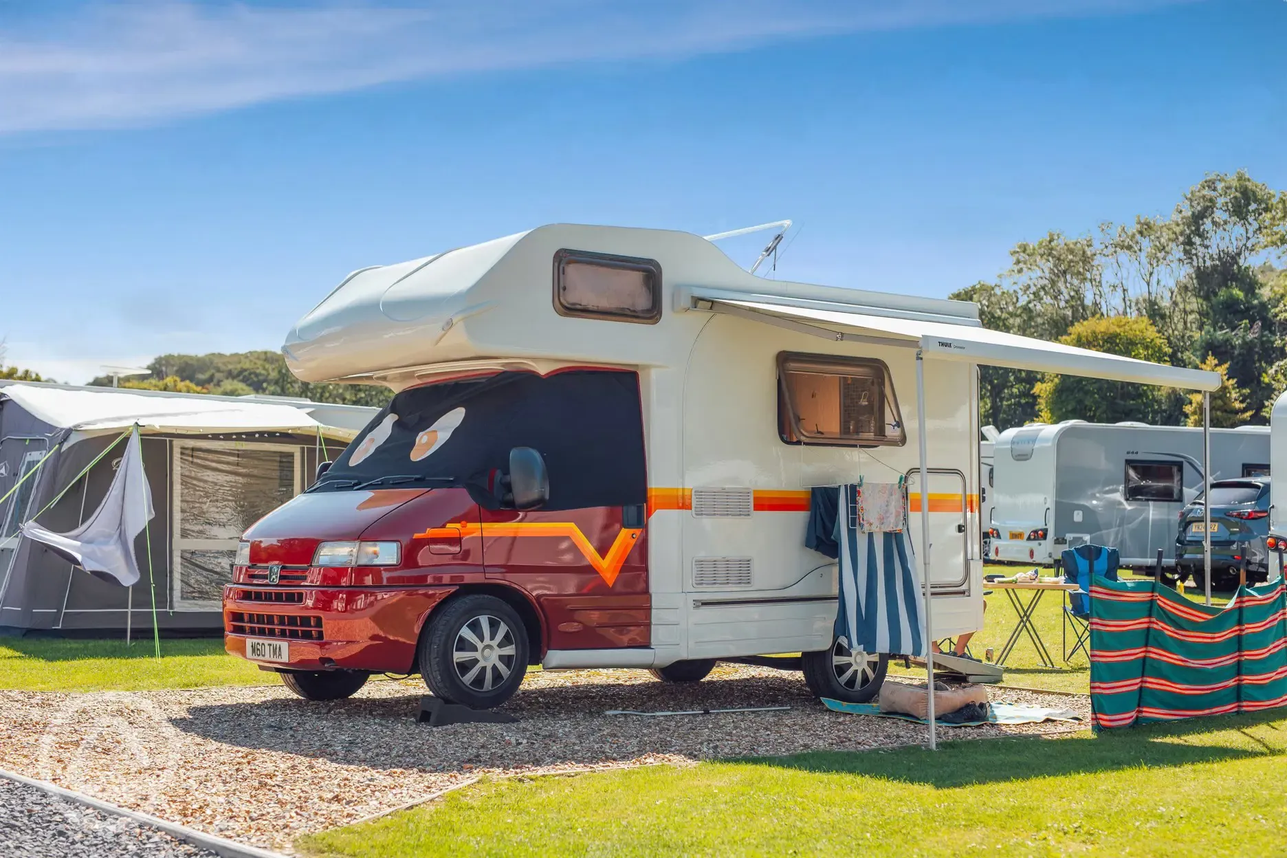 Campervan on an electric gravel hardstanding pitch