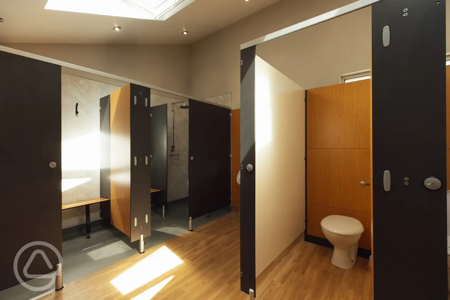 Toilets and showers cubicles with a changing bench