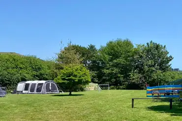 Large tents on grass pitches at Tremarne Campsite