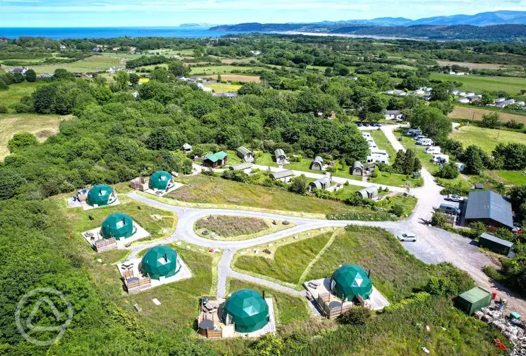 Aerial of Brynteg Glamping with the coast in the background