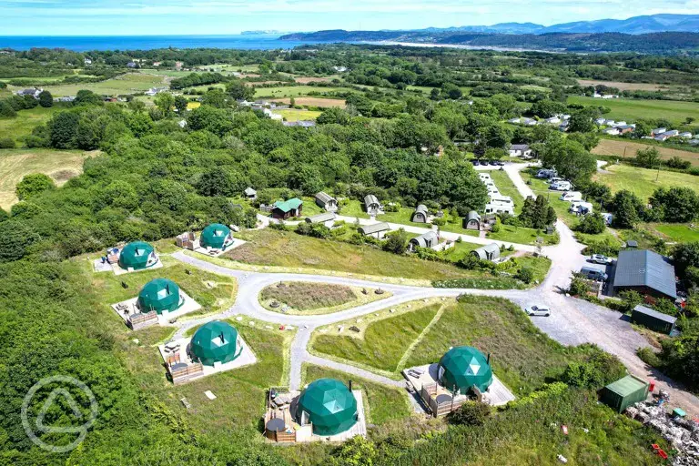Aerial of Brynteg Glamping with the coast in the background