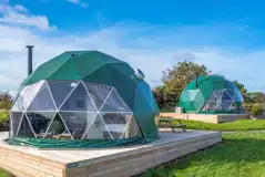 Geodomes with private wooden deckings with wood-fired hot tubs Geodomes with private wooden deckings with wood-fired hot tubs