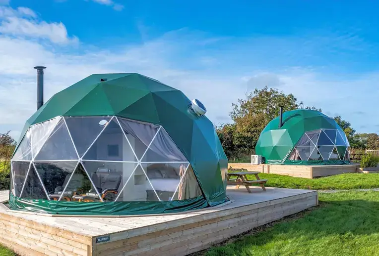 Geodomes with private wooden deckings with wood-fired hot tubs