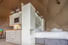 Geodome interior with a king size bed and kitchenette Geodome interior with a king size bed and kitchenette