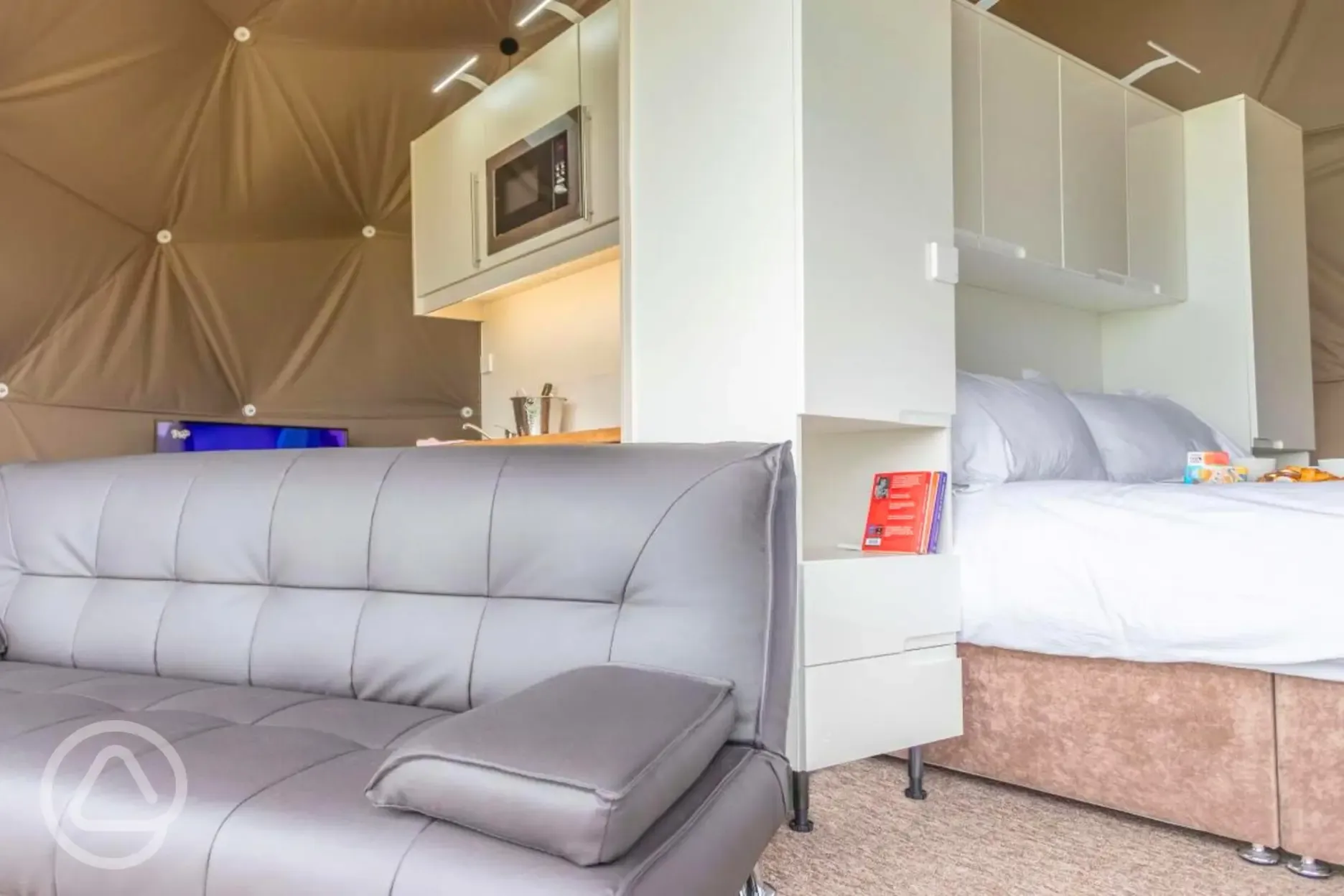 Geodome interior with a leather sofa bed
