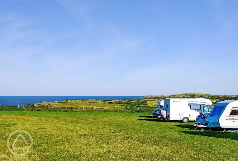 Non electric grass pitches with Anglesey sea views