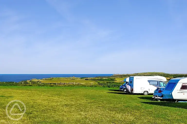 Non electric grass pitches with Anglesey sea views