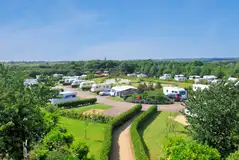 Northern Close with hedges between hardstanding pitches with 16 amp hook ups