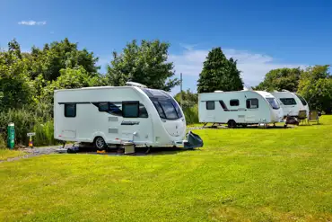 Caravans on fully serviced pitches at Ysgubor Fadog Caravan Site