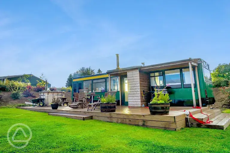 Eco bus (four person) with decking, outdoor furniture, and a hot tub