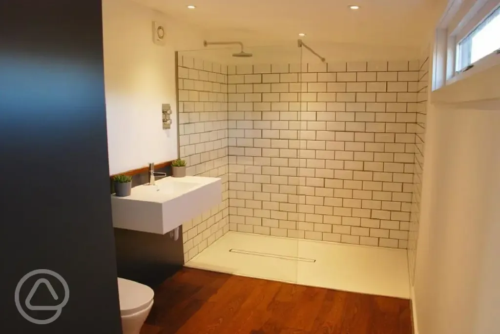 Luxury glamping bus (six person) ensuite with a rainfall shower and toiletries