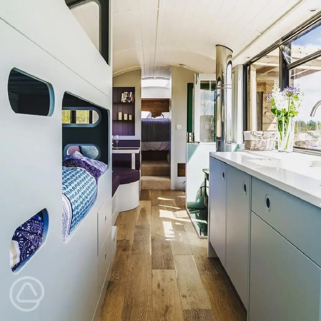 Luxury glamping bus (four person) interior with bunk beds