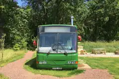 Eco bus (two person) front view with an outdoor seating area