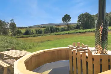 Eco bus wood-fired hot tubs with Lammermuir Hills views and seating