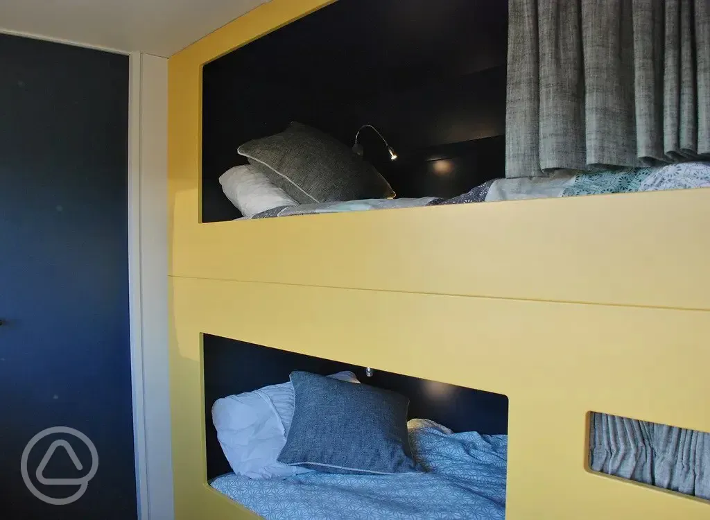 Luxury glamping bus (six person) bunk beds with bedding provided