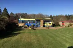 Luxury glamping bus (two person) with a fence, decking, hot tub, and seating