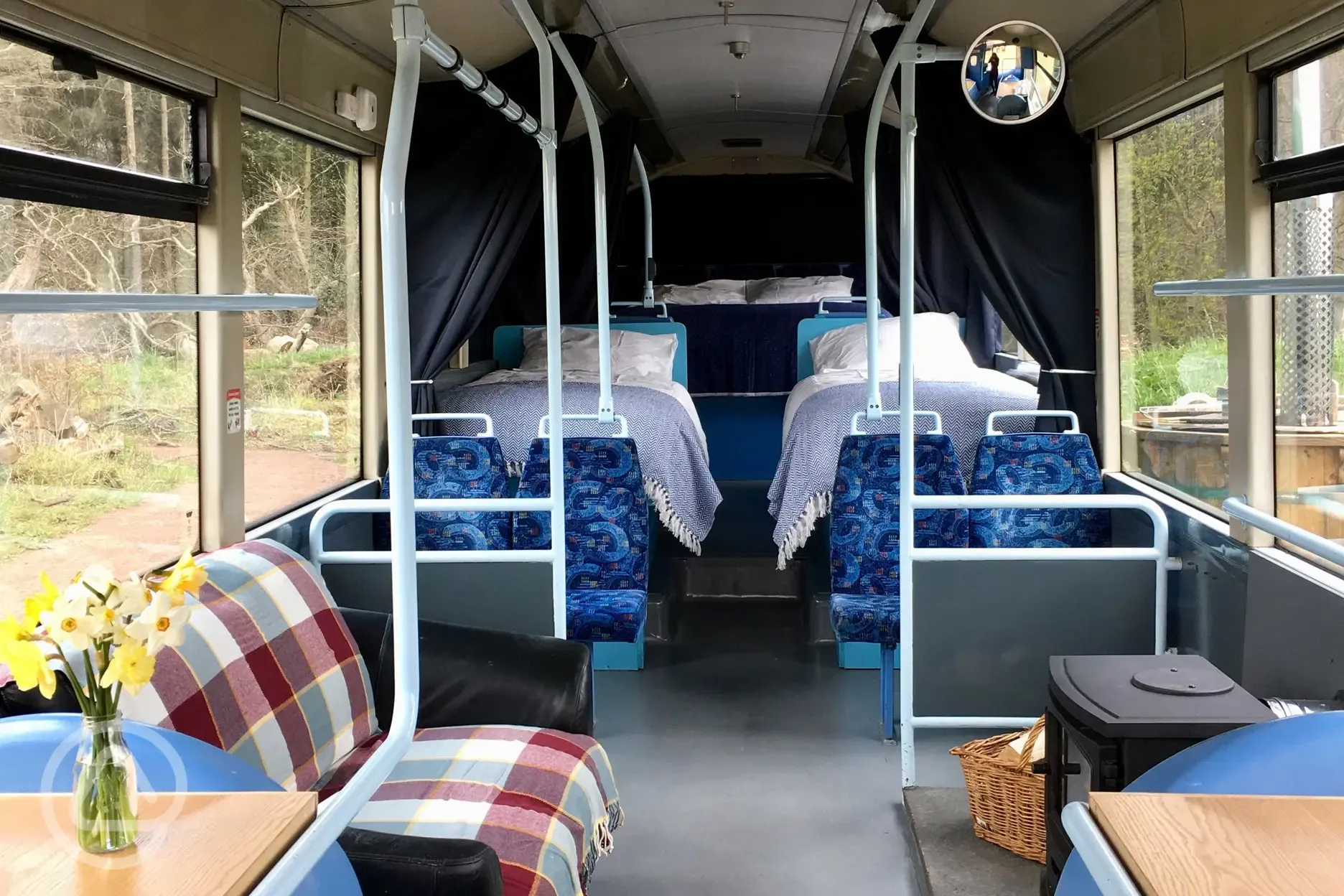 Eco bus (four person) interior with a log stove and sofa