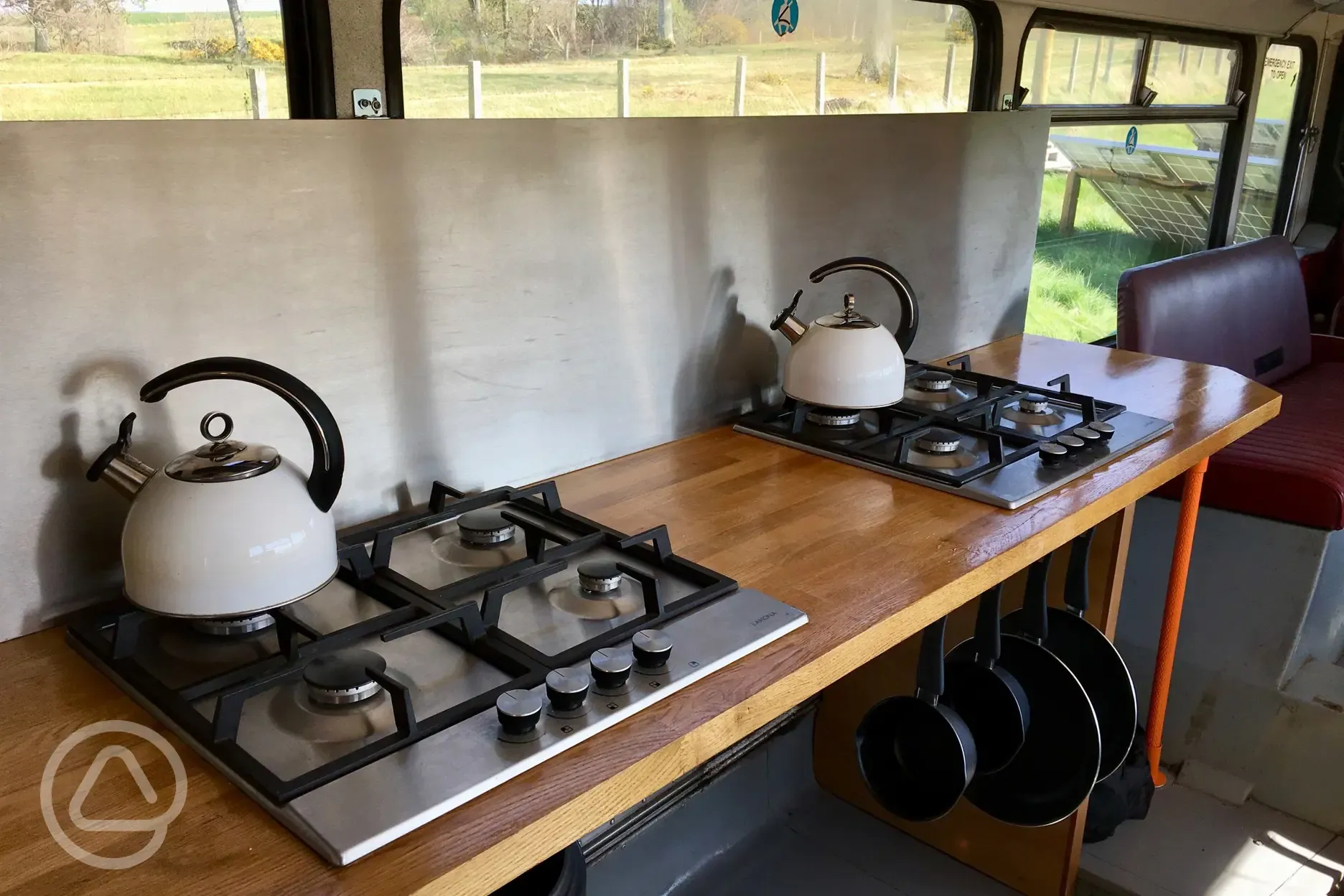 Eco bus (six person) kitchen area with hobs, kettles, and pans