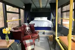 Eco bus (two person) interior with a king size bed and bedding provided