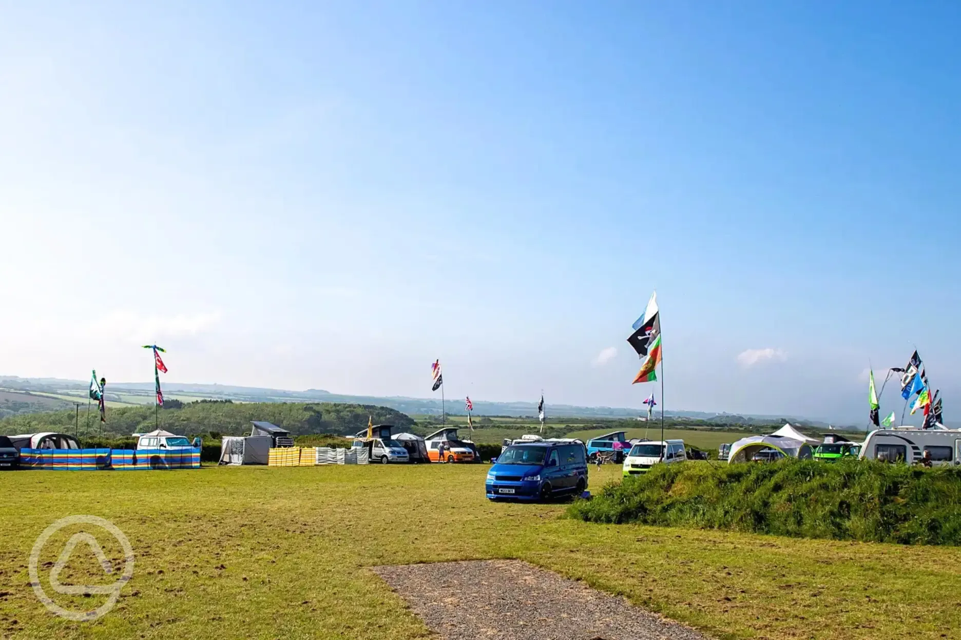Grass pitches with a meeting of campervans