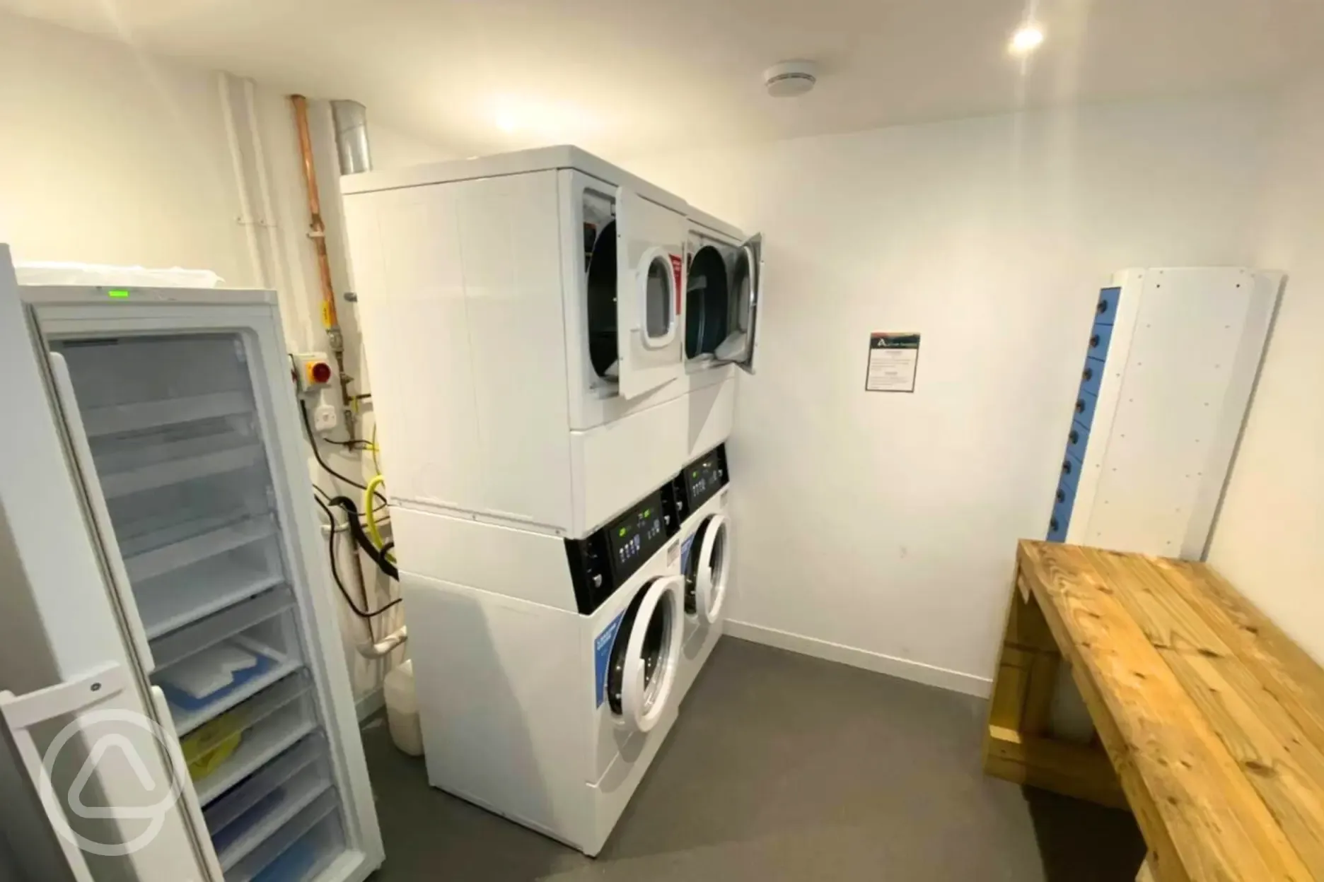 Laundry room with a communal fridge, freezer and charging lockers