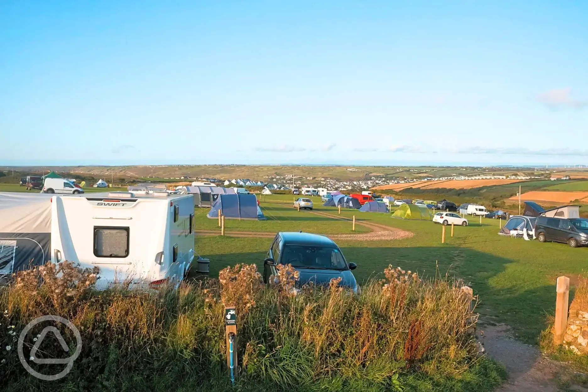 Electric grass pitches with 16 amp hook ups and nearby water taps