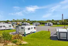 Fully serviced hardtstanding pitches with views towards the fairground