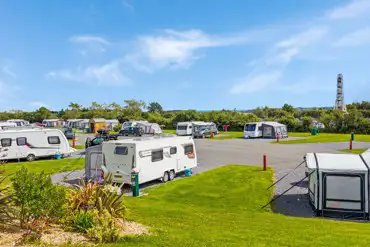 Fully serviced hardtstanding pitches with views towards the fairground