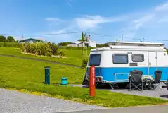 Hardstanding touring pitches (12m x 10m) with service bollards
