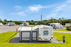 Fully serviced touring pitches (12m x 10m) with grass surroundings
