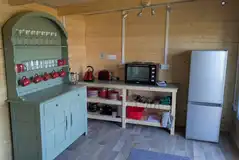  Robin Roundhouse yurt - equipped kitchen rea with crockery and utensils