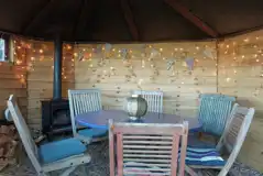 Hedgehog Hollow yurt - dining area with a fire place