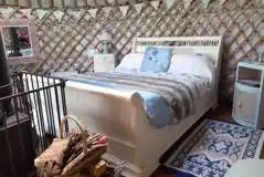  Pipistrelle Nook yurt - interior with double bed and soft furnishings