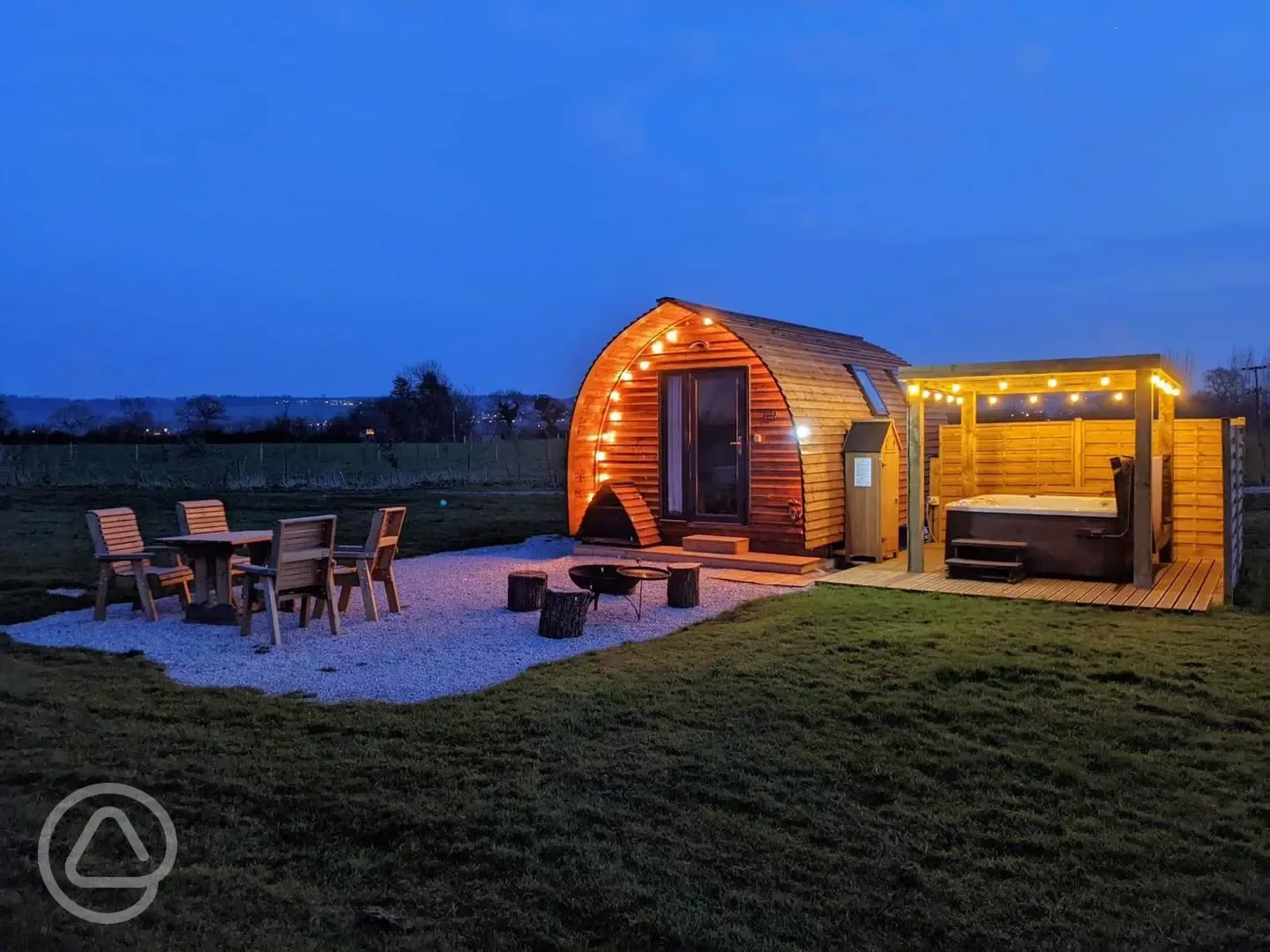 Ensuite Deluxe Wigwam Pod with electric hot tub at night