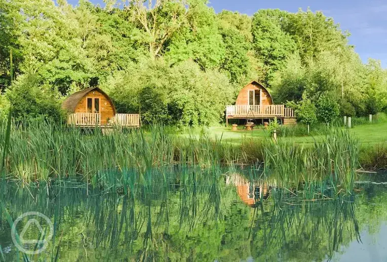 Wigwam pods with the wildlife pond