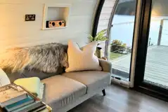 Sildvik and Sunset ensuite glamping pod interiors with a sofa