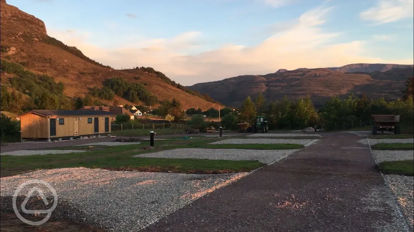 Hardstanding pitches (optional electric) at sunset with mountain views Hardstanding pitches (optional electric) at sunset with mountain views
