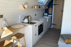 Sildvik and Sunset ensuite glamping pod interiors with a kitchenette