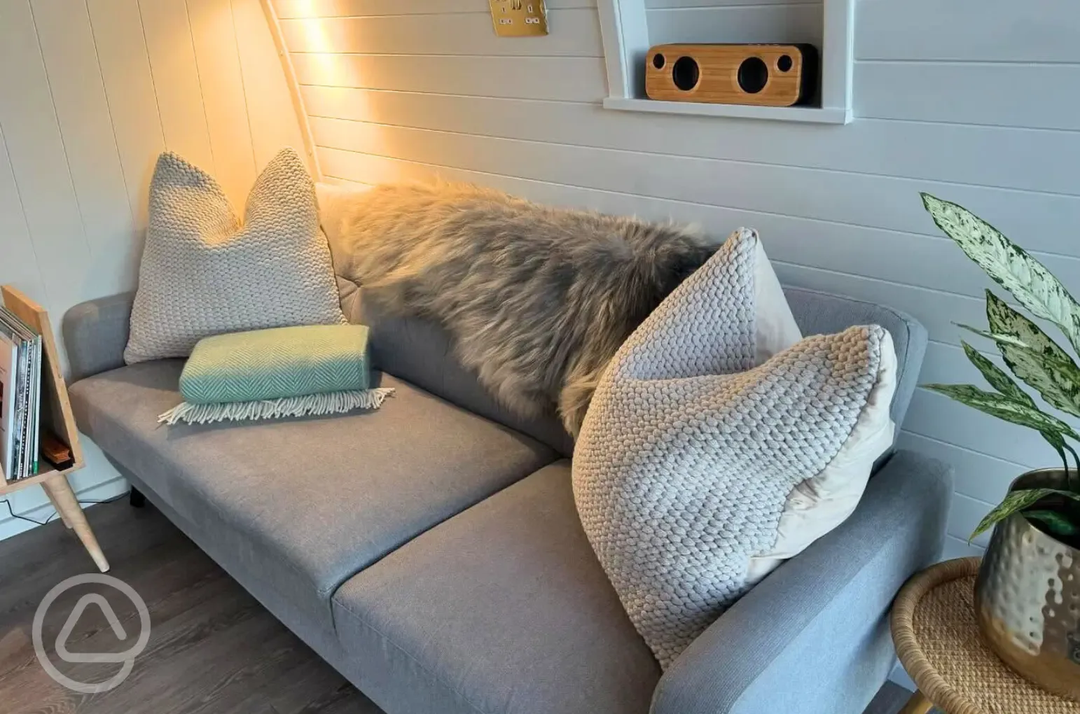 Sildvik and Sunset ensuite glamping pod interiors with a sofa Sildvik and Sunset ensuite glamping pod interiors with a sofa