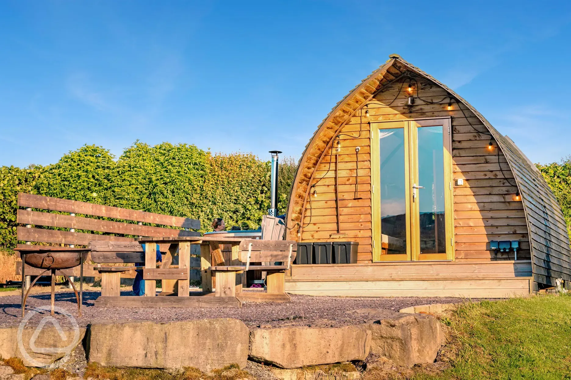 Glamping pod with a private wood-fired hot tub, picnic bench and fire pit